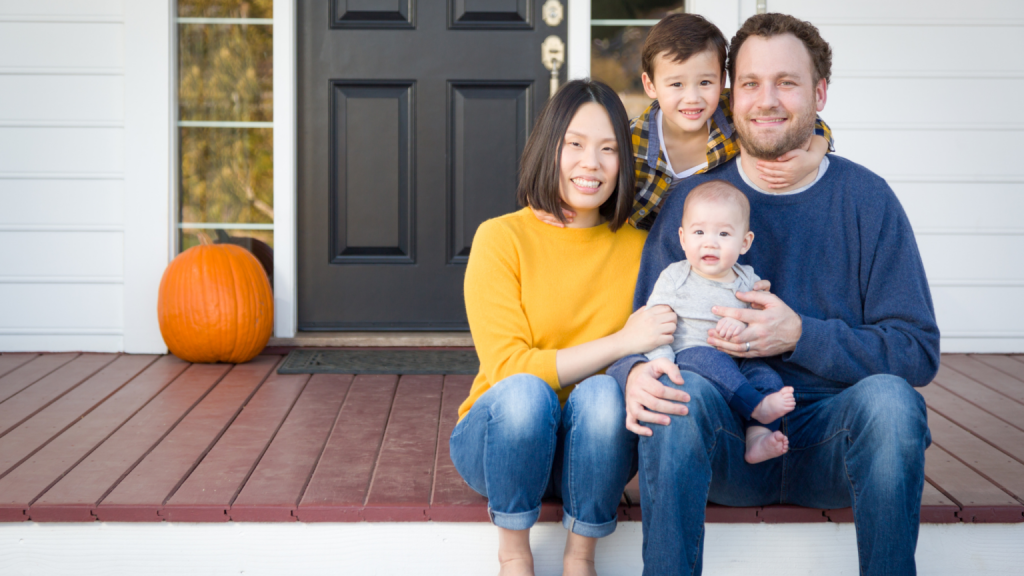 A happy family in front of a house with a fiberglass door